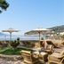 Grand Hotel Ambasciatori in Sorrento terrace with wicker seating, umbrellas, and sea views over the bay