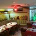Hotel Art in Sarajevo dining area with red-lit lounge seating and set tables