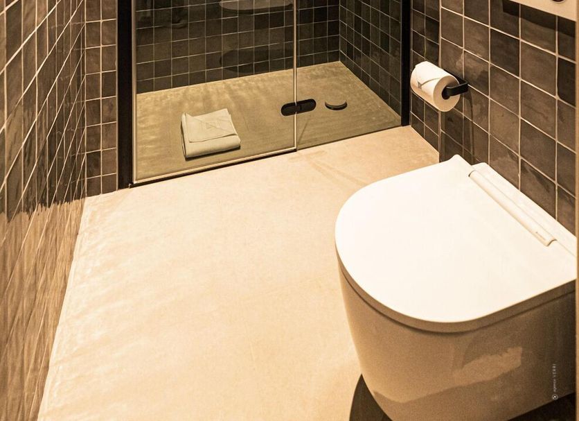Hôtel Le Mosaïque in Narbonne bathroom with glass walk-in shower and wall-mounted toilet