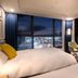 Ventimo Hotel & Residence Jeju room with floor-to-ceiling windows and city lights in Jeju City