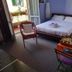 Il Riposo del Guerriero Guesthouse in Genoa, guest room with bed, chair, and balcony door open