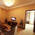 Qilu International Hotel Harbin guest room with sofa, chairs, coffee table and TV