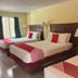 Buena Vista Inn Motel in Delhi guest room with three beds, lamps and a window view