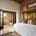 The Inn at Manzanillo Bay in Ixtapa guest room with king bed, balcony doors, and sea-inspired decor