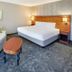 Courtyard by Marriott Cleveland Beachwood guest room with king bed, sofa, and coffee table
