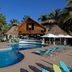 Margaritaville Island Reserve Riviera Cancun pool with loungers, palapa umbrellas and tropical palm trees in Puerto Morelos