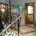 Hotel Planaiblick in Schladming lobby with tiled floor, green chair, brochure board and shelving