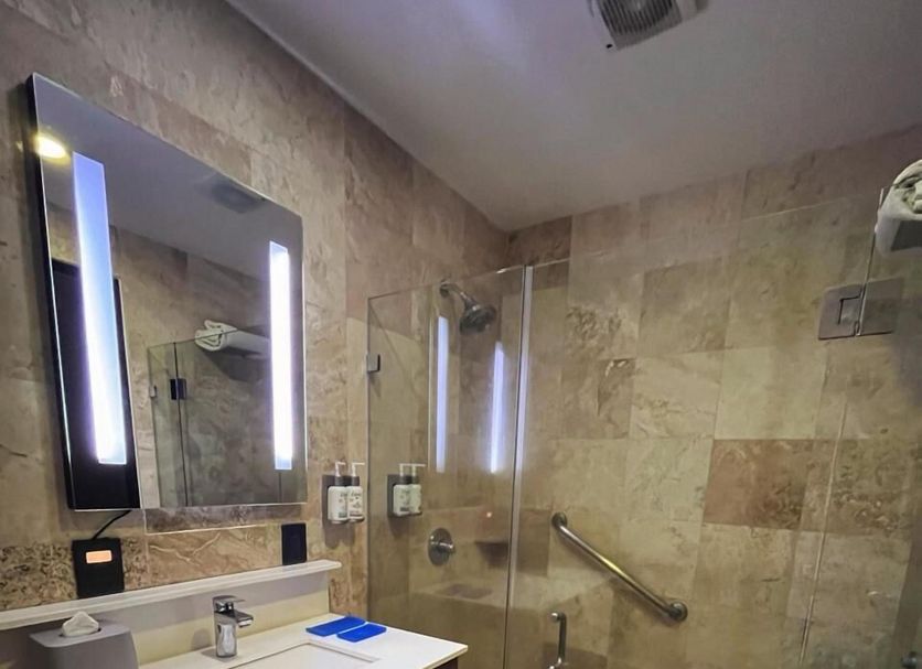 Holiday Inn Express Mexico Santa Fe bathroom with glass shower, vanity and lit mirror in Mexico City