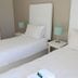 Saffron House Guesthouse in Cape Town with two neatly made twin beds and bedside lamps
