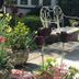 West Lodge Hotel in Aylesbury garden patio with potted flowers and white metal bench
