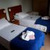 Pousada Ilha Morena in Florianopolis: twin beds with blue covers in a simple guest room