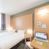 B&B HOTEL Montluçon twin room with two single beds, window, desk and wall-mounted TV