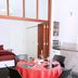 Bon Marie B&B in Hamilton: dining table set for four beside a bed and compact kitchen area