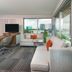 Hampton Inn & Suites Atlanta Buckhead Place room with sofa, desk, TV and city view in Atlanta