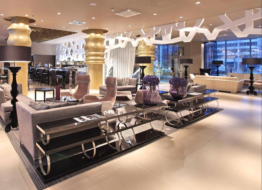 Zijin Hotel Belgrade lobby lounge with modern seating, decorative columns, and city views in Belgrade