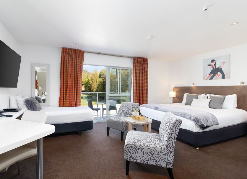 Century Park, Nelson hotel room with two beds, balcony doors and a seating area