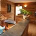 Residence Plein Soleil in Villarodin-Bourget reception with wood-paneled walls and a guest seated at the desk