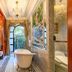 Moller Villa Hotel Shanghai bathroom with freestanding tub, chandelier, ornate wood paneling and balcony view