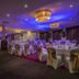 Westgrove Hotel Kildare banquet hall with round tables, white chair covers, and purple ambient lighting