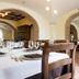La Vecchia Torre in San Nicola Manfredi dining room with set tables and arched brick openings