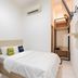 Wisma Rimadi Guest House Jakarta simple room with bed, desk, air conditioning, and narrow entryway