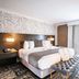 The Burgundy Hotel, Tapestry Collection by Hilton in Little Rock: stylish guest room with king bed and tufted bench