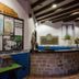 Hotel Villa de Cabrales in Las Arenas reception with stone front desk, maps, and exposed beam ceiling