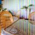 Villa Welwitshia in Praia do Carvoeiro with wicker patio chairs and a glass-topped outdoor table