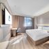 Hanting Express Hangzhou Cuiyuan Branch room with queen bed, desk, and window view in Hangzhou