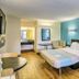 Motel 6 Dickson, TN guest room with king bed, desk, and blue accent wall