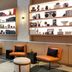 The Sound Hotel Seattle Belltown lobby lounge with orange chairs, shelves, and a sofa in Seattle