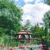 Belweder in Ustroń: garden gazebo beside a lily pond with pink water lilies and lush trees