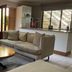 Bellgrove Guest House Sandton in Johannesburg lounge with sofa, armchair, coffee table and kitchen counter