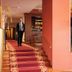 Hotel Maxim in Peschiera Borromeo lobby staircase with red carpet and a man walking inside