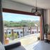 Apart Hotel Brisas do Amor, Pipa: balcony room with TV, mural and view of greenery and rooftops