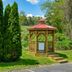 Red Roof Inn Hillsville gazebo in landscaped garden with trees and steps, Hillsville