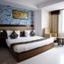The Grand Radiant Hotel, Lucknow: guest room with king bed, seating area and large window