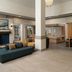 Hilton Garden Inn Richmond South/Southpark lobby with seating area, front desk, and market in Colonial Heights