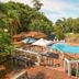 Country 2 Coast Motor Inn Coffs Harbour pool and deck surrounded by tropical trees