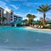 Home2 Suites by Hilton Orlando at FLAMINGO CROSSINGS Town Center pool with palm trees in Bay Lake