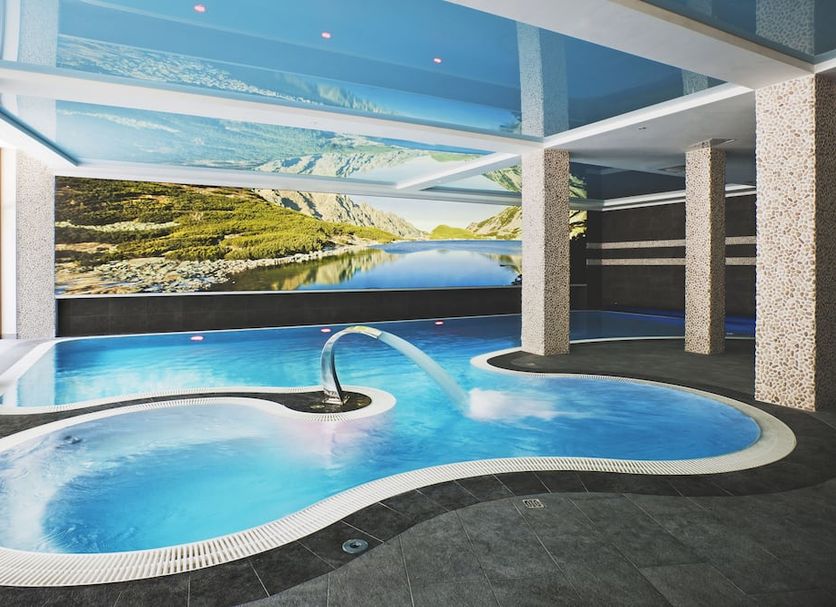 Apartamenty Przy Hotelu Zywieckim indoor pool with wall mural and lounge area in Przylekow