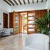 Finca Son Arnau in Selva: bright lobby with wooden double doors, lounge chairs and potted plant