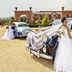 Bride posing beside vintage cars at Velmore Hotel & Spa in Pretoria