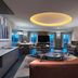 Hyatt Centric The Woodlands suite with modern living room, dining area, and large windows
