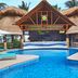 Margaritaville Island Reserve Riviera Cancun in Puerto Morelos, with a resort pool and thatched-roof bar