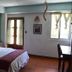 Eco Suites Uxlabil Guatemala guest room with bed, desk, and window in Guatemala City
