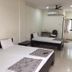 Vrp Guest House Bhuj guest room with two beds, desk, air conditioning, and window