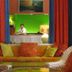 Colony Hotel & Cabana Club Delray Beach lounge with wicker chairs, colorful sofa, and bar view