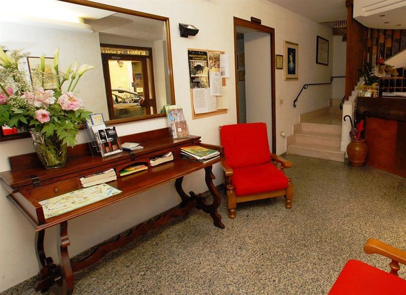 Albergo Umbria lobby in Città di Castello with reception desk, red chair, mirror and staircase