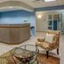 Federal City Inn & Suites New Orleans lobby with front desk, seating area and glass coffee table